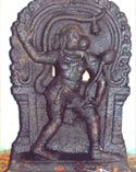 Sri Anjaneya wears a lock of hair, a belled tail, and a lotus flower in his hand